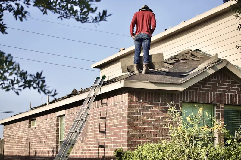Professional roofer working on a residential roof in Brownlee